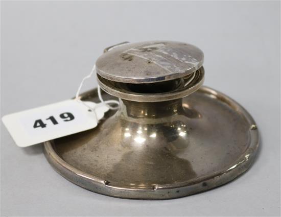 A silver capstan inkwell.